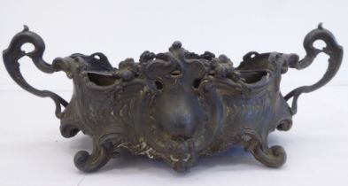 A Victorian style cast metal twin handled planter with an oval copper reservoir lining  6"h  13"w
