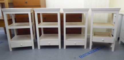 A set of four modern cream painted, three tier occasional tables, raised on square legs  28"h  17"sq