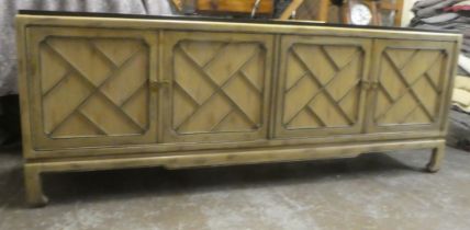 A modern Chinese mahogany shabby chic finished sideboard with two pairs of panelled doors, raised on