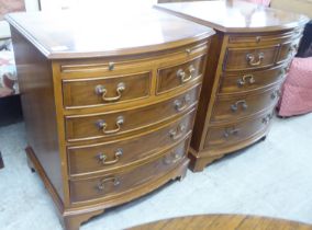 A pair of modern yewwood bowfront five drawer bedside chests, raised on bracket feet  26"h  23"w