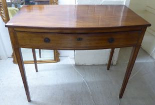 A 19thC mahogany bow front single drawer side table, raised on square, tapered legs  30"h  36"w