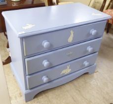 A modern light blue painted and rabbit decorated, three drawer dressing chest, raised on bracket
