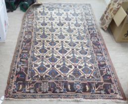 A Persian rug, decorated with geometric elephant foot motifs, on a multi-coloured ground  54" x 86"