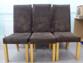 A set of six modern brown suede covered dining chairs, raised on square forelegs