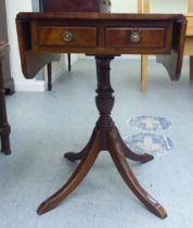 A Victorian style mahogany sofa design table with fall flaps, over a pair of drawers, raised on