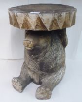 A modern carved wooden pedestal, fashioned as a seated bear cub  17"h