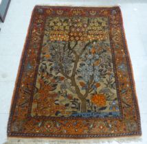 A Persian rug with tree and bird motifs, on a red ground  62" x 42"