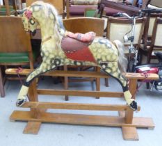 A 1930s painted wooden rocking horse, on a trestle stand  41"h