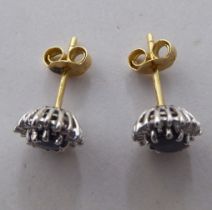 A pair of 18ct gold earrings, each set with a central sapphire, surrounded by diamonds