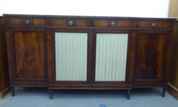 A Regency style mahogany breakfront sideboard, comprising four inline short drawers, over four