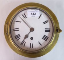 A late 19th/early 20thC black painted iron and brass cased bulkhead timepiece; faced by a white