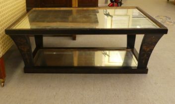 A modern black lacquered and gilded two tier framed mirror topped coffee table, raised on swept