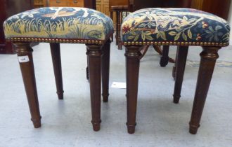 A pair of Victorian style beech framed and tapestry upholstered square stools, raised on turned,