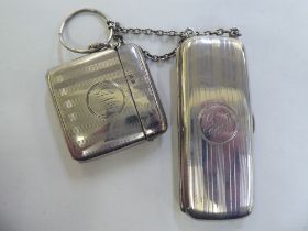 A silver vesta case with engine turned decoration and hinged cap; and a silver folding single