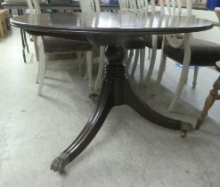 A Regency style mahogany breakfast table with a crossbanded tip-top, raised on splayed tripod base