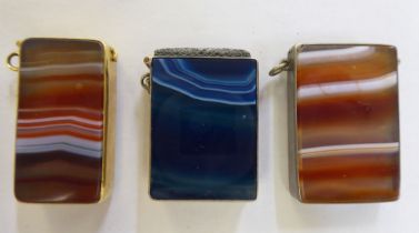 A late 19thC Scottish white metal and banded blue agate vesta case with a suspension ring, strike