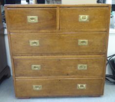 An early 20thC oak two part, campaign style chest, the two short/three long drawers with recessed,