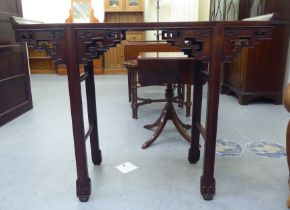 A modern Chinese mahogany and walnut altar table of traditional design with a panelled top,