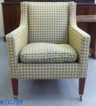 A modern Edwardian style box type enclosed armchair, upholstered in patterned square fabric with a