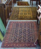 Three rugs: to include a Persian example, on a mustard coloured ground  54" x 78"