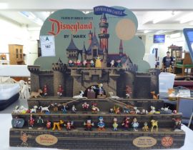 A Disney Land by Marx Toys, a printed card display, comprising a collection of miniature plastic