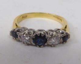 An 18ct bi-coloured gold ring, set with alternating diamonds and sapphires