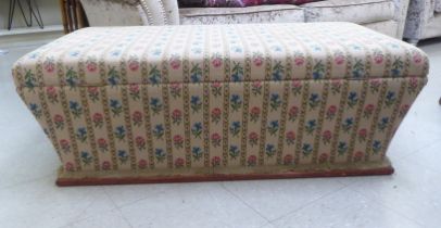 A Victorian style casket shape box ottoman with a hinged lid, stud upholstered in floral patterned