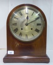 An early 20thC Georgian style string inlaid mahogany cased, round arched mantel clock; the