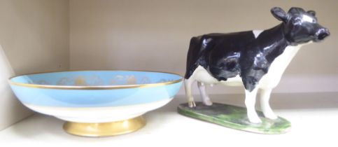 A Bayer ceramic model, a cow with black and white markings  7.25"h; and an Aynsley china Fine Art