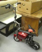 A battery powered miniature 'Rev & Go' scooter