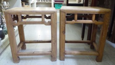 A pair of Chinese elm framed work stools with mitred and panelled tops, raised on square section
