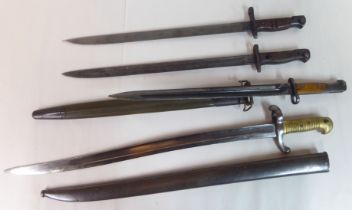 Four various late 19thC to mid 20thC military bayonets: to include a French example inscribed on the