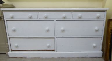 A 19thC style off-white painted pine, seven drawer dresser, on a plinth  32"h  63"w