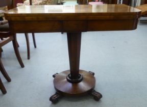 An early Victorian mahogany card table, the rotating and folding D-shaped top with a green baize