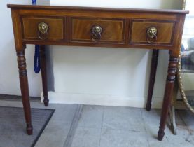 A Regency mahogany side table with crossbanded and string inlaid ornament, comprising three inline