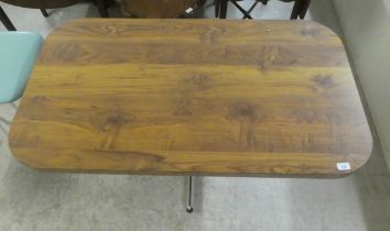 A modern wood effect kitchen table, raised on a chromium plated pedestal and quatrefoil base  29"