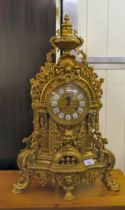 A modern Victorian design, gilt metal cased mantel clock of ornate architectural design, faced by