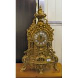 A modern Victorian design, gilt metal cased mantel clock of ornate architectural design, faced by