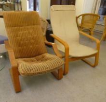 Two similar mid 20thC beech framed chairs with open arms, on cantilevered underframes