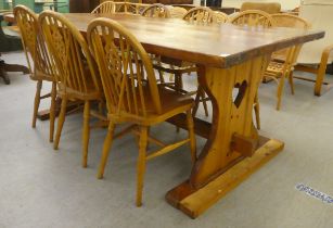 A modern pine refectory design kitchen table, raised on plank ends  30"h  64"L; and a matching set