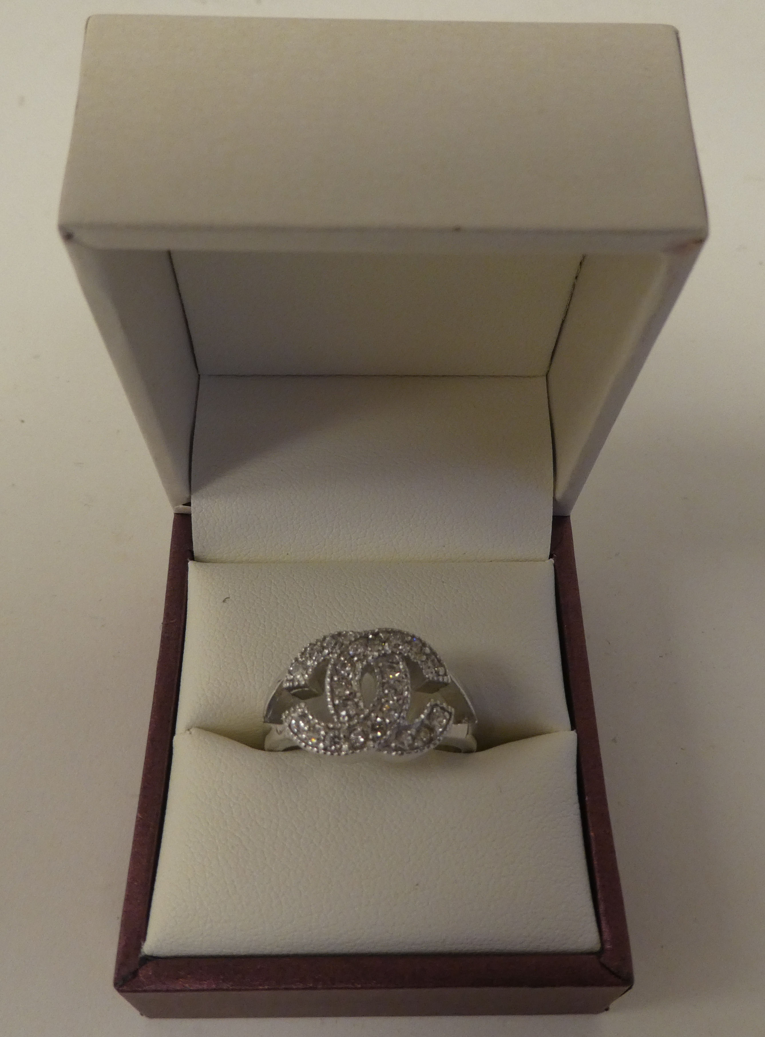 A silver coloured metal cubic zirconia set dress ring