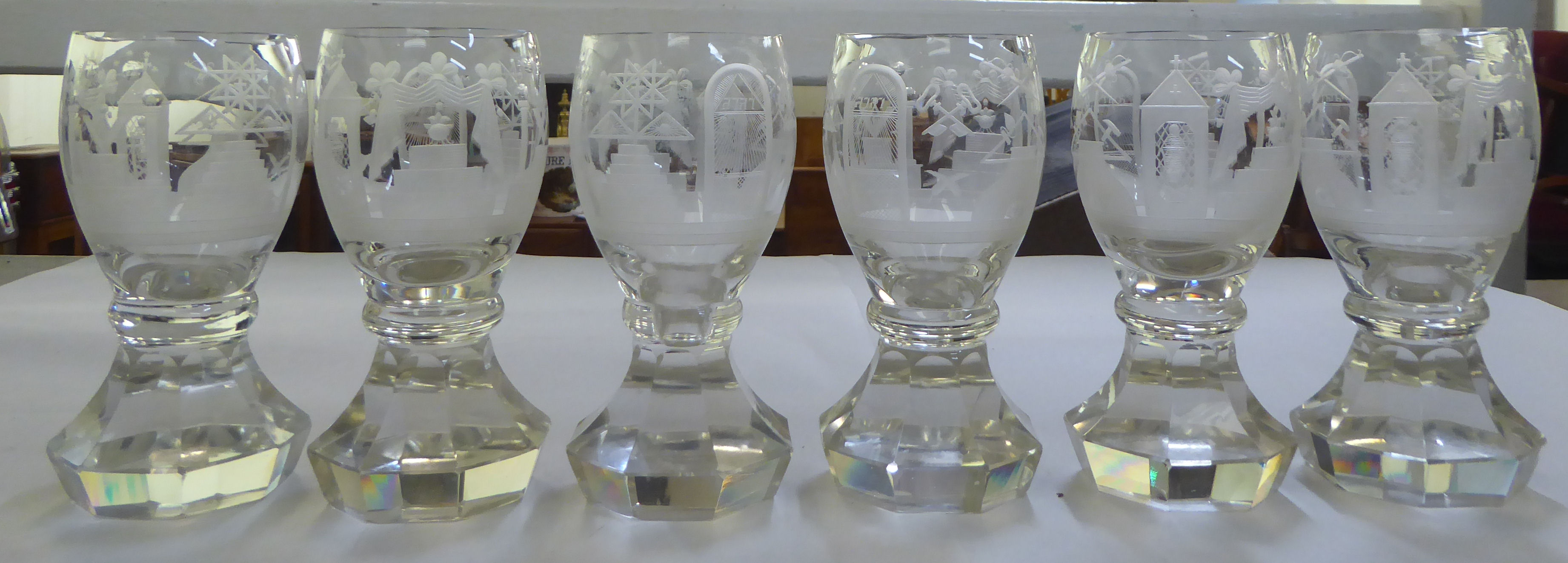 A set of six clear glass tumblers engraved with Masonic motifs and emblems  6"h