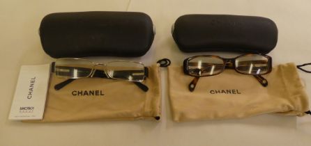 Two pairs of Chanel prescription glasses, viz. a black framed pair  cased with original carton and