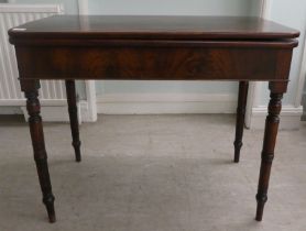 A mid Victorian mahogany tea table, the foldover top with round corners, raised on ring turned,