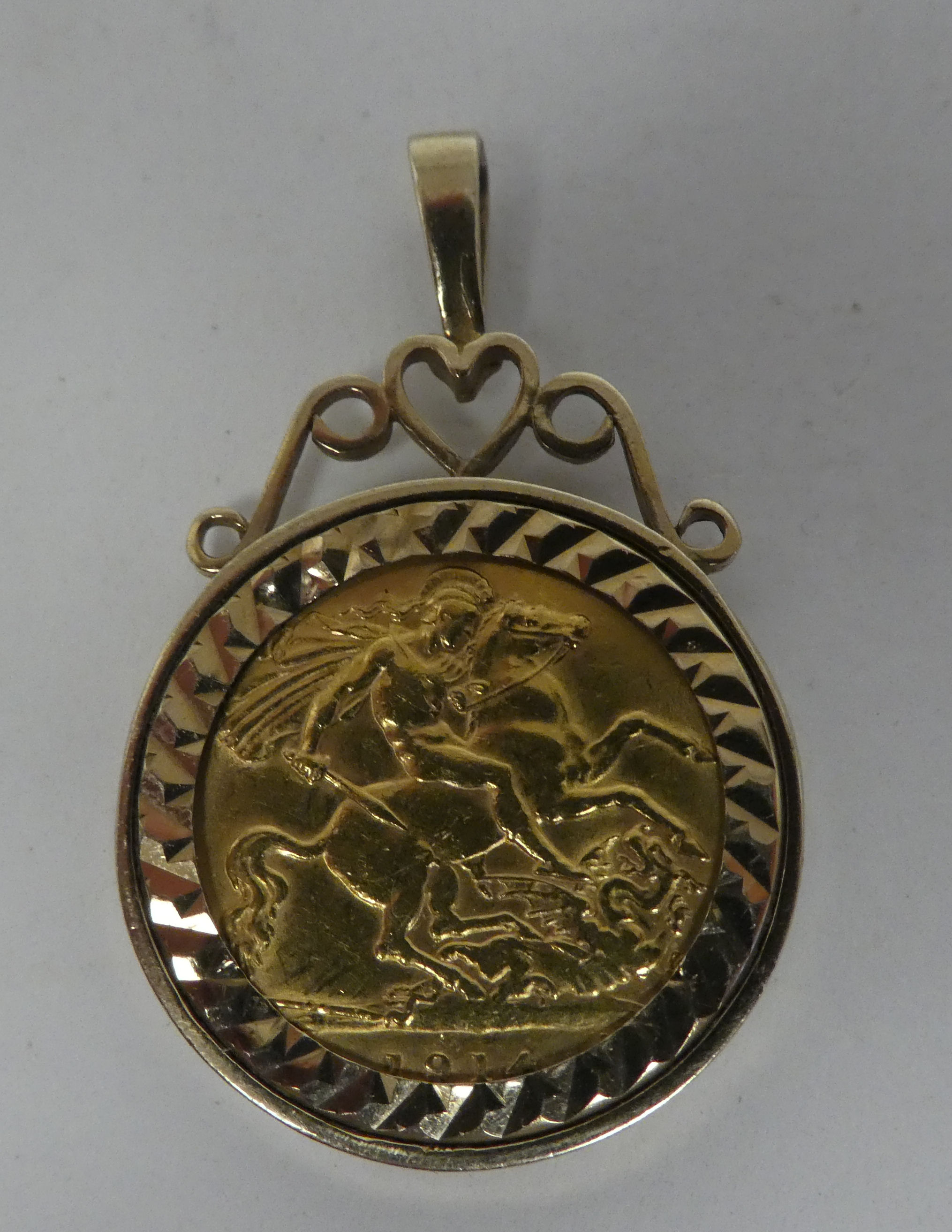 A George V half sovereign, St George on the obverse  1914, in a 9ct gold, scrolled pendant mount - Image 2 of 2