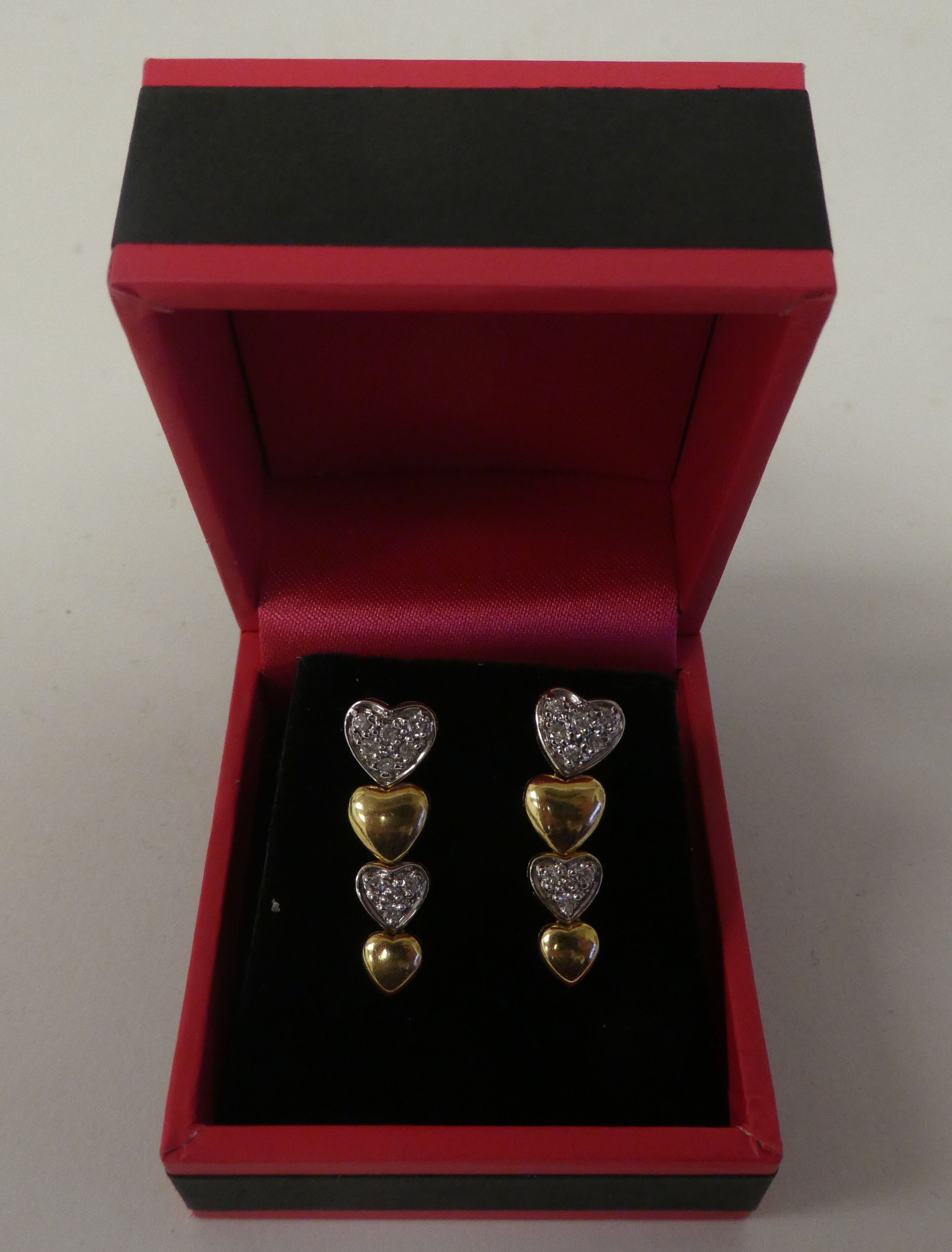 A pair of 14ct gold and diamond set, multiple heart shape earrings