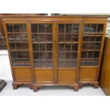 An Edwardian mahogany breakfront bookcase with four astragal glazed doors, raised on bracket feet