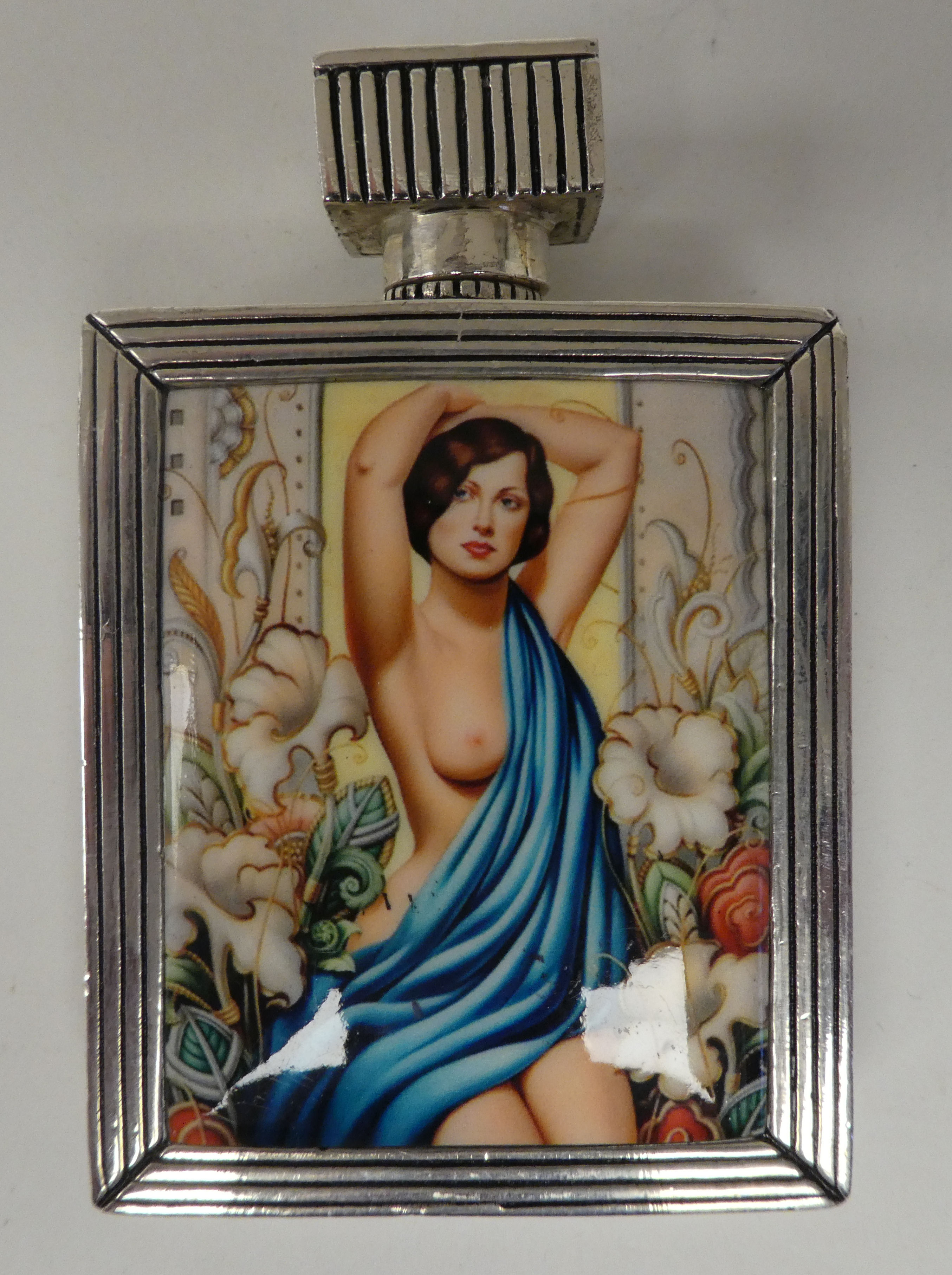 An Art Deco inspired white metal perfume bottle, decorated with an enamelled study of a posing nude