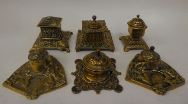 Six variously designed, early/mid 20thC decoratively cast brass desktop lidded inkwells