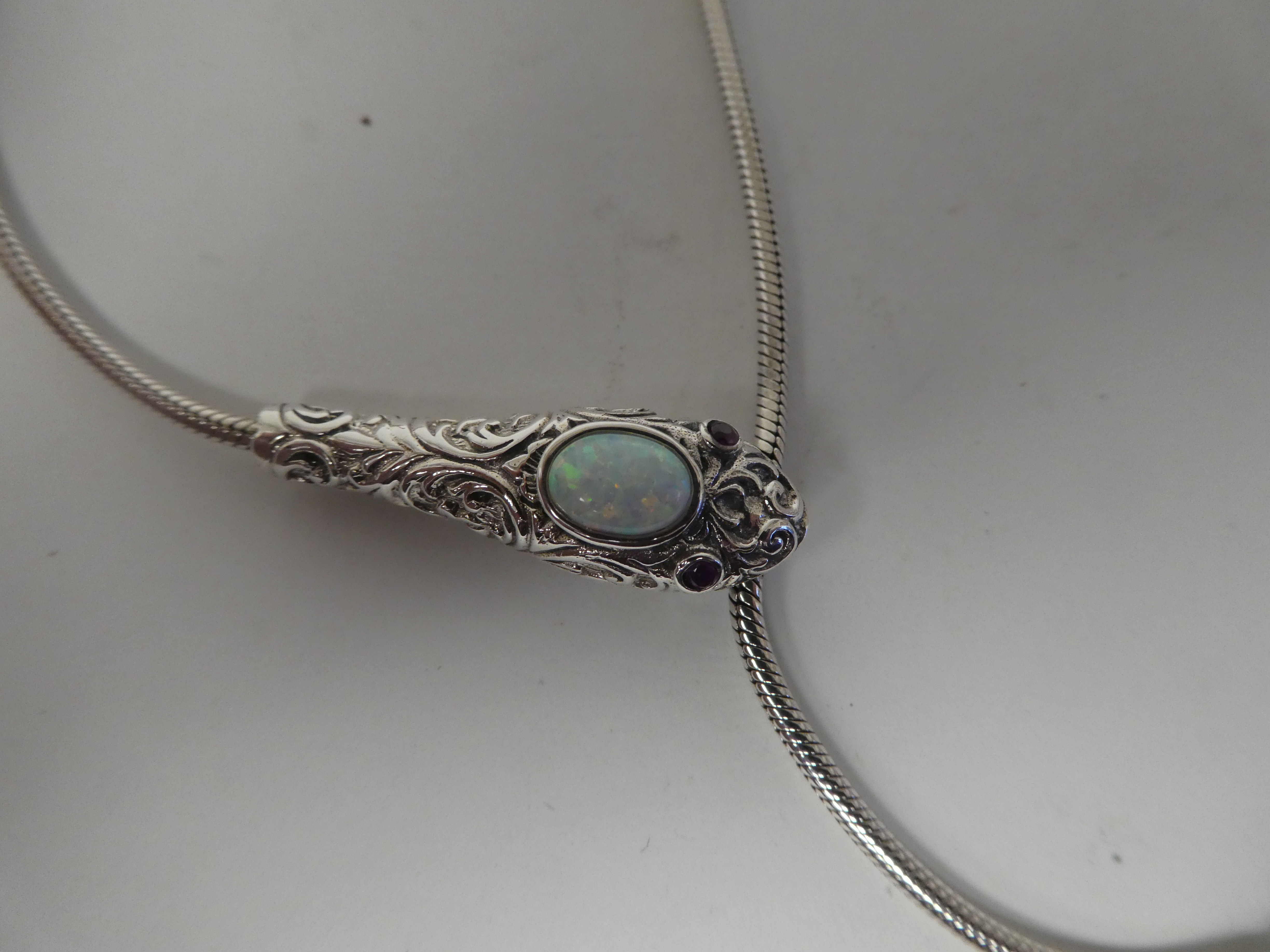 A silver coloured metal, opal set snake necklace with ruby set eyes - Image 2 of 3